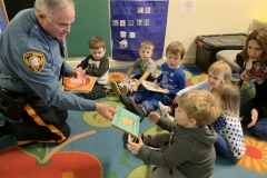 Fall’s Township’s Officer Yeager giving books to children