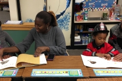 A family enjoys reading together at Family Literacy Night in Morrisville.